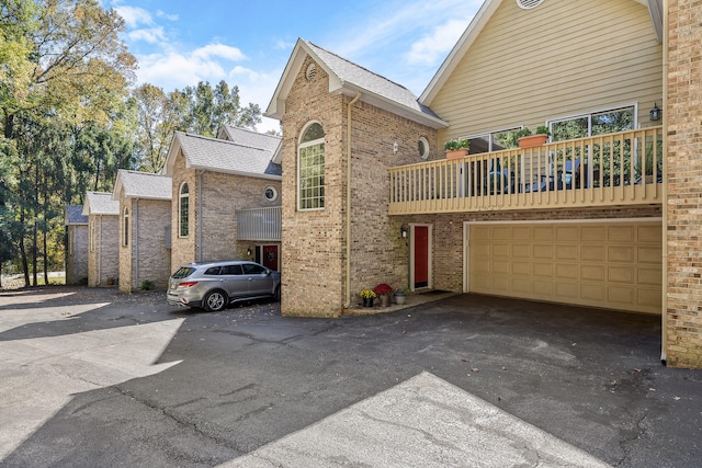 view of front of property with a balcony and a garage