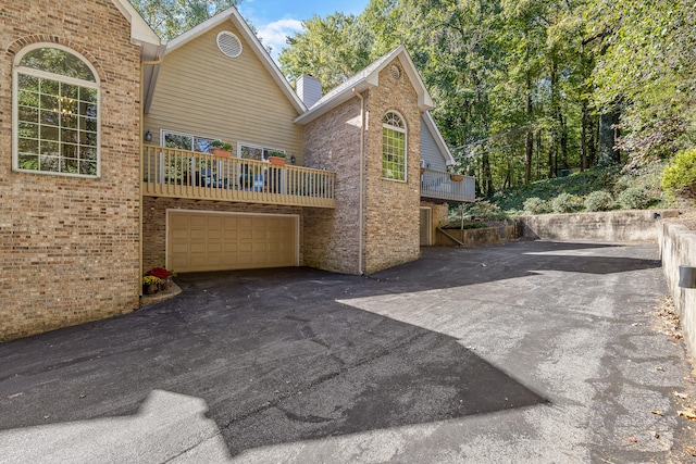 view of patio / terrace featuring a balcony and a garage