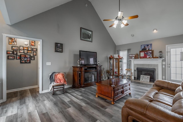 living room with a fireplace, high vaulted ceiling, dark hardwood / wood-style floors, and ceiling fan