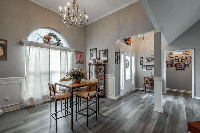 dining space featuring decorative columns, ornamental molding, and a chandelier