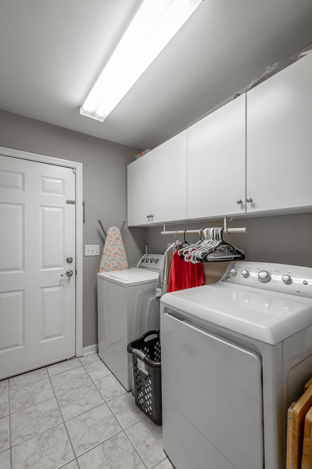 washroom featuring independent washer and dryer and cabinets