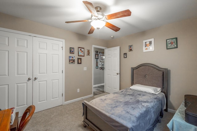 carpeted bedroom featuring ceiling fan and a closet