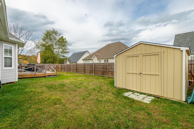 view of yard with a storage unit and a deck