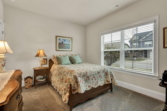 carpeted bedroom featuring visible vents and baseboards