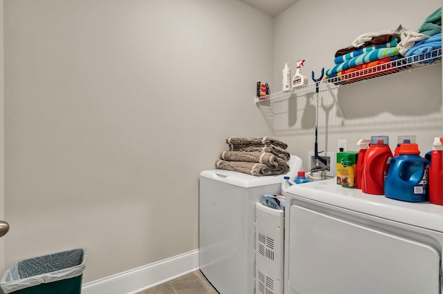 laundry area featuring washing machine and clothes dryer and tile patterned floors