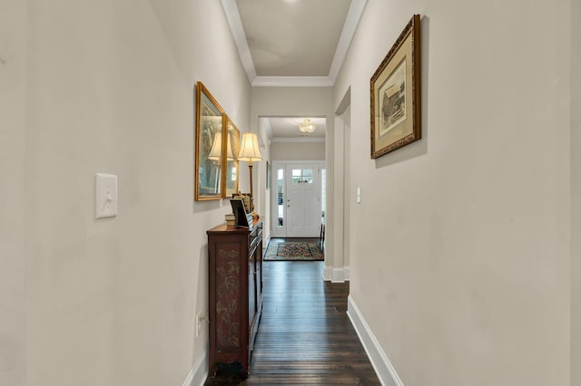 hall with ornamental molding, dark wood-style flooring, and baseboards