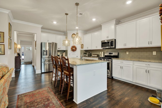 kitchen featuring decorative backsplash, ornamental molding, dark wood-style flooring, stainless steel appliances, and a sink