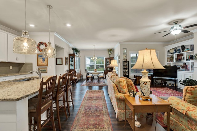 living room with ceiling fan, dark hardwood / wood-style floors, sink, and ornamental molding