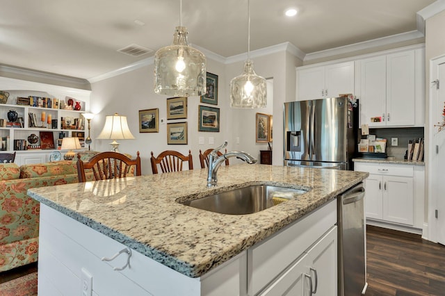 kitchen with dark wood finished floors, stainless steel appliances, visible vents, ornamental molding, and a sink