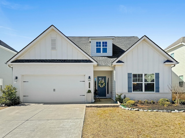 modern farmhouse with a garage, driveway, board and batten siding, and roof with shingles