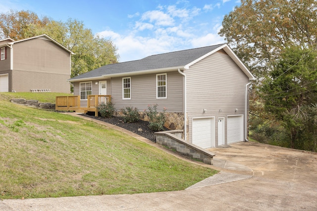 view of home's exterior featuring a garage, a yard, and a deck