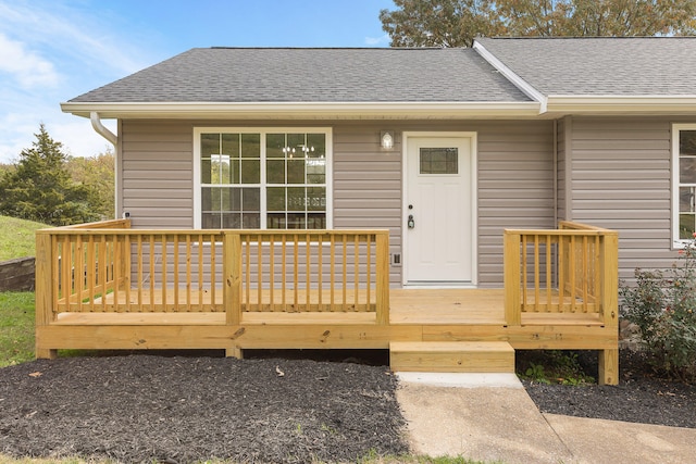 view of exterior entry with a wooden deck