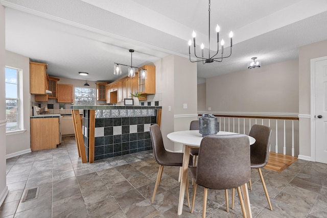 dining area with a textured ceiling and an inviting chandelier