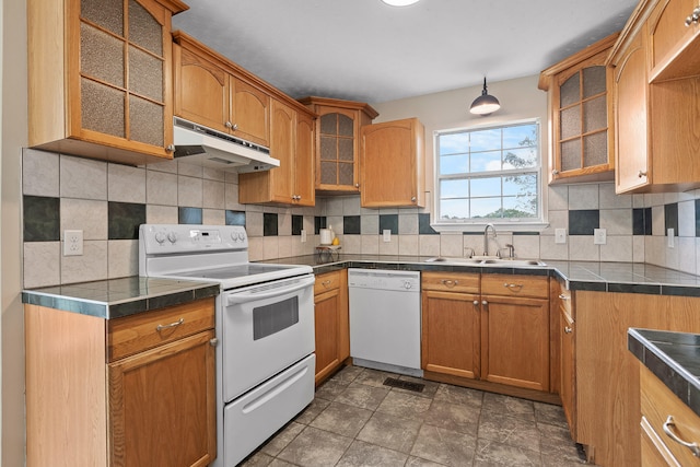 kitchen featuring decorative backsplash, tile countertops, sink, and white appliances