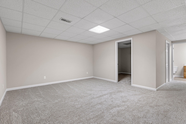 interior space featuring a paneled ceiling and carpet