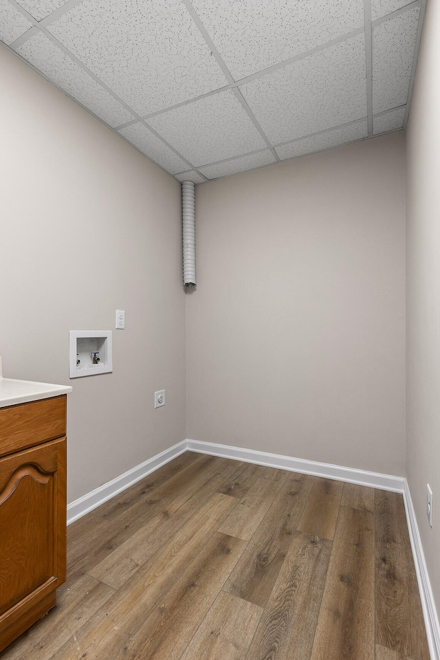 laundry room with washer hookup, cabinets, and light hardwood / wood-style flooring