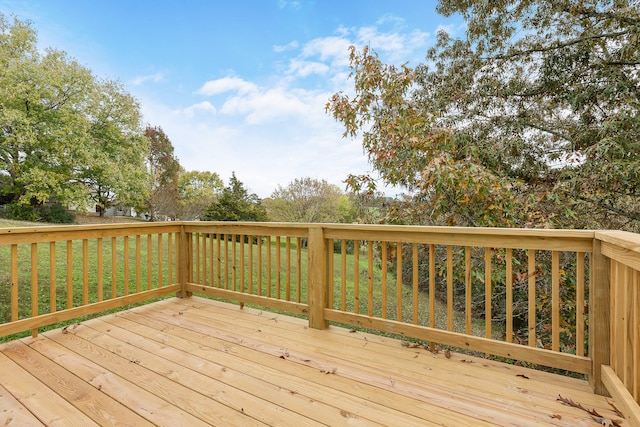 wooden terrace featuring a yard