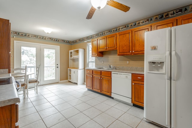 kitchen featuring light tile patterned floors, white appliances, ceiling fan, and sink