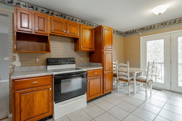 kitchen featuring light tile patterned flooring and electric stove