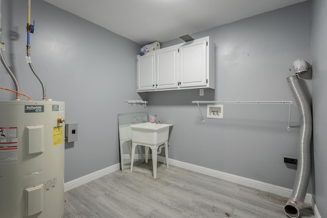 washroom featuring water heater, hookup for a washing machine, cabinets, and light hardwood / wood-style floors