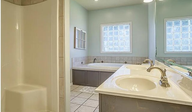 bathroom featuring a washtub, sink, and tile patterned floors