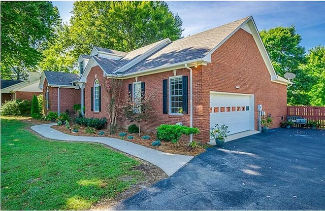 view of front of property featuring a garage and a front yard