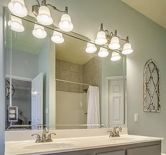 bathroom featuring vanity, a shower with shower curtain, and lofted ceiling