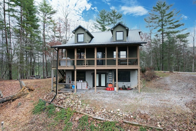 rear view of property featuring a wooden deck