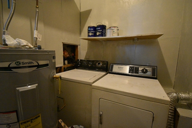 clothes washing area with water heater and washer and clothes dryer