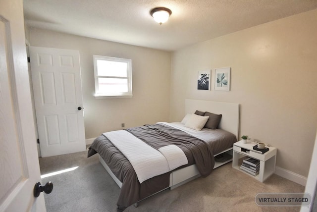 bedroom with carpet flooring and a textured ceiling