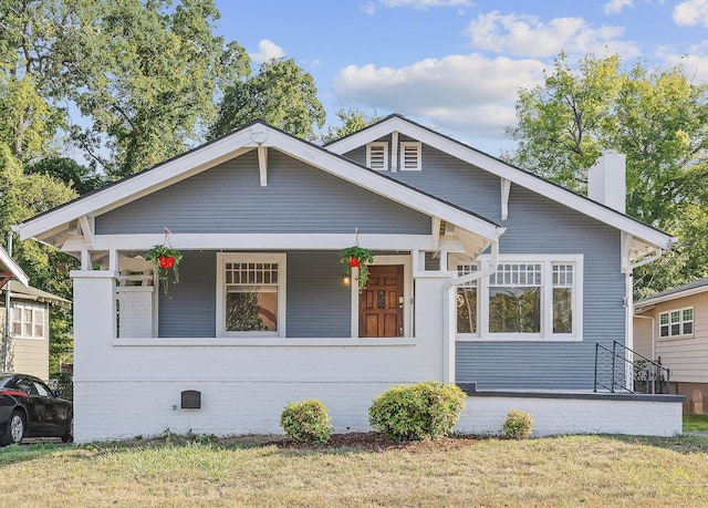 bungalow-style house with a front lawn