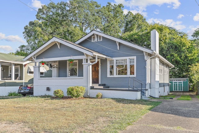 bungalow-style house with a porch and a front yard