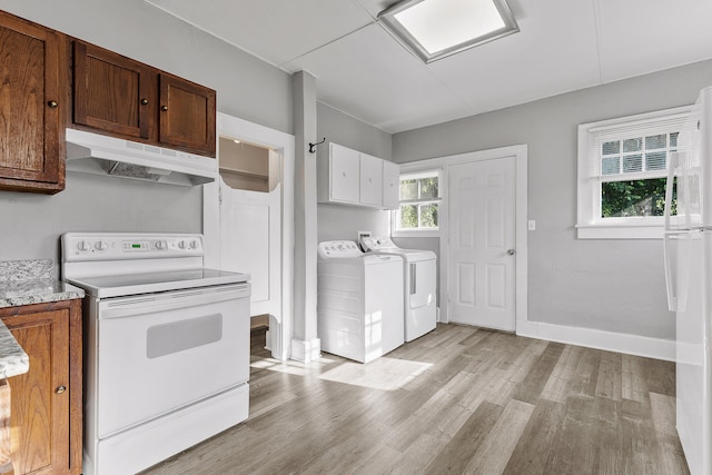 kitchen featuring light wood-type flooring, washing machine and dryer, and white range with electric cooktop