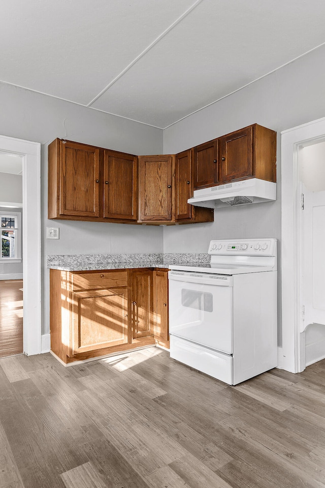 kitchen with light hardwood / wood-style floors and white electric stove