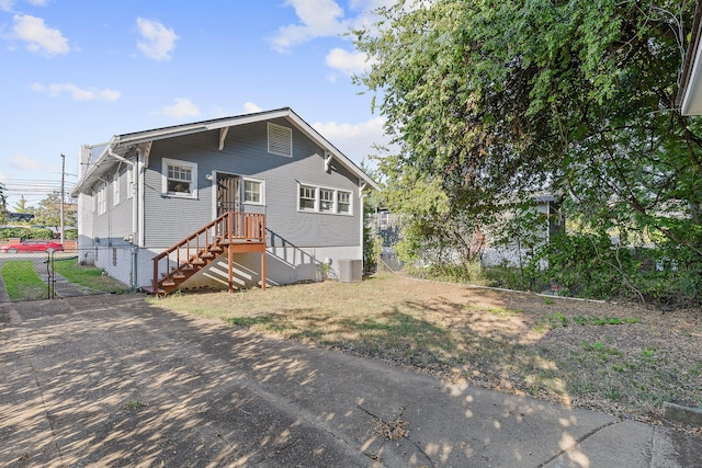 rear view of house featuring central AC unit