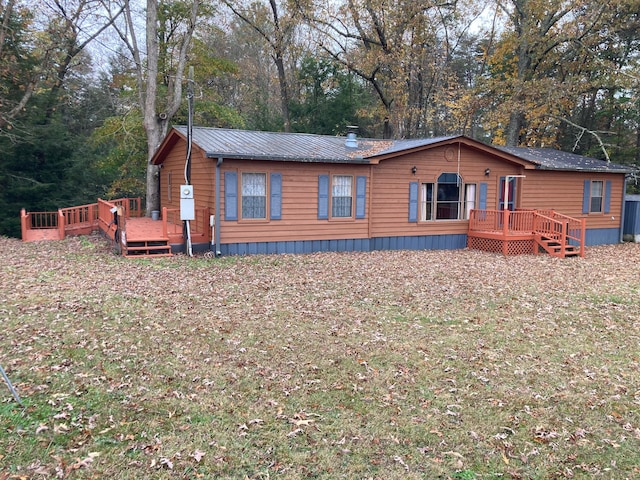 view of front of home featuring a front yard and a deck