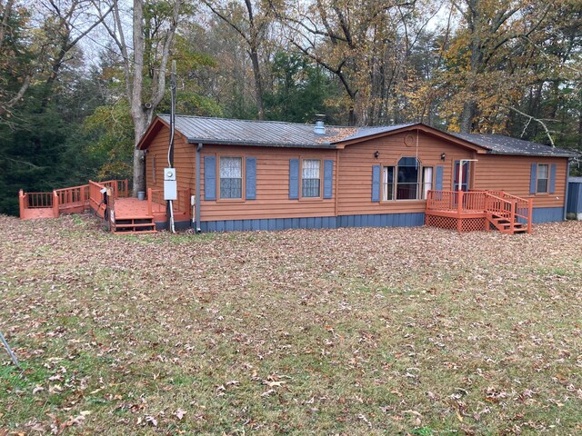 134 Old Spring Rd, Rising Fawn, GA 30738 - view of front of home with a wooden deck and metal roof