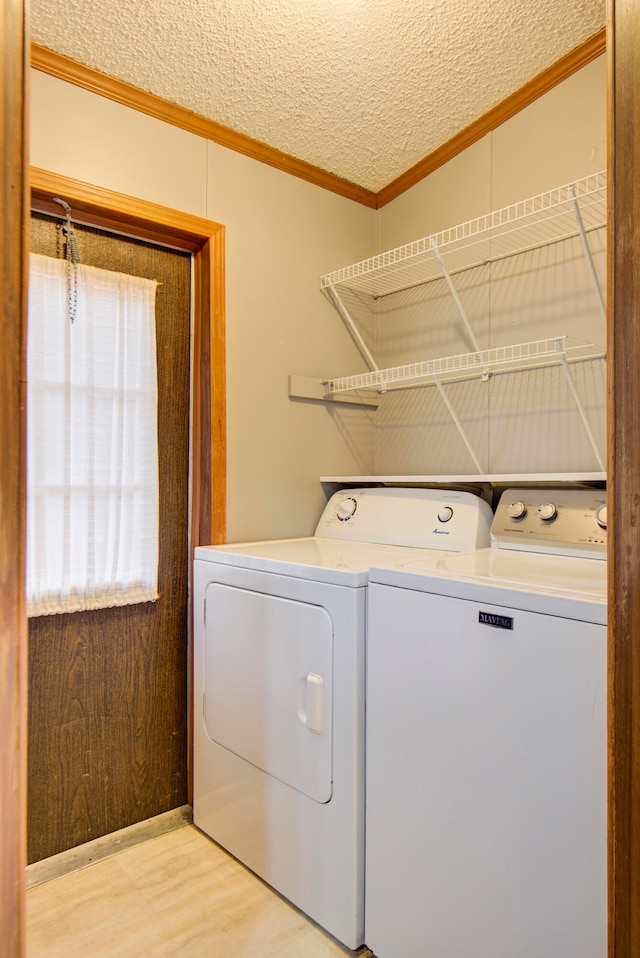 washroom featuring washer and clothes dryer, a wealth of natural light, a textured ceiling, and light hardwood / wood-style flooring