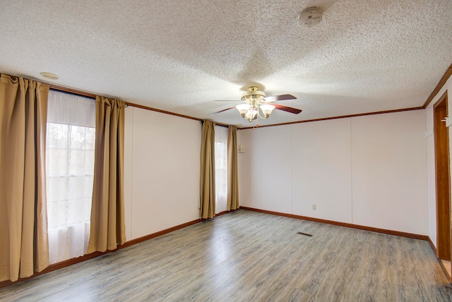 unfurnished bedroom featuring a textured ceiling, light wood-type flooring, ornamental molding, and ceiling fan