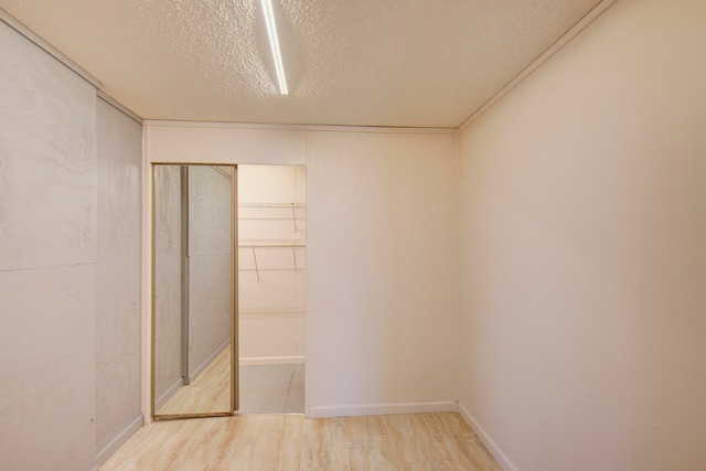 interior space featuring a textured ceiling and a closet