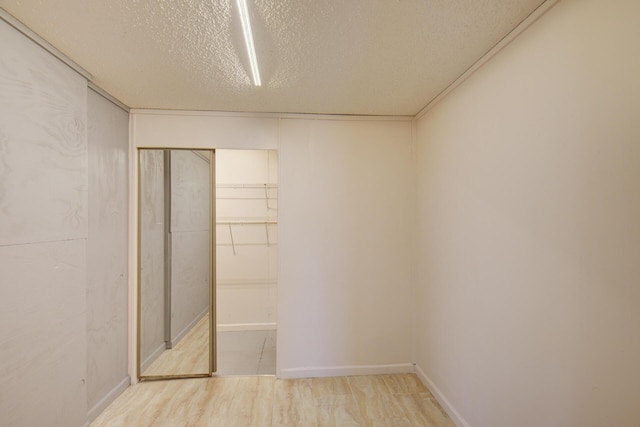 134 Old Spring Rd, Rising Fawn, GA 30738 - unfurnished bedroom featuring a textured ceiling, wood finished floors, a closet, and baseboards