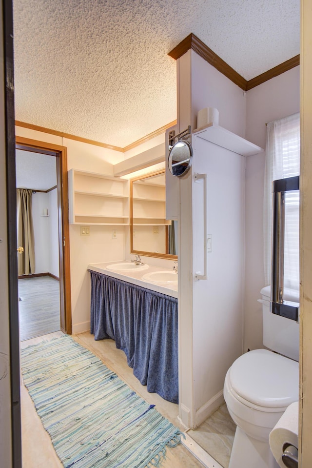 134 Old Spring Rd, Rising Fawn, GA 30738 - bathroom with crown molding, a textured ceiling, toilet, baseboards, and double vanity