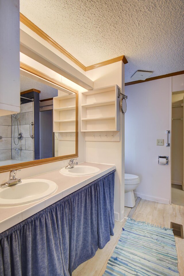 134 Old Spring Rd, Rising Fawn, GA 30738 - bathroom with ornamental molding, toilet, a textured ceiling, double vanity, and an enclosed shower