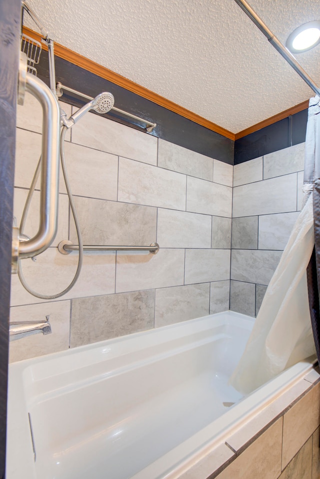 bathroom featuring shower / bath combo and a textured ceiling