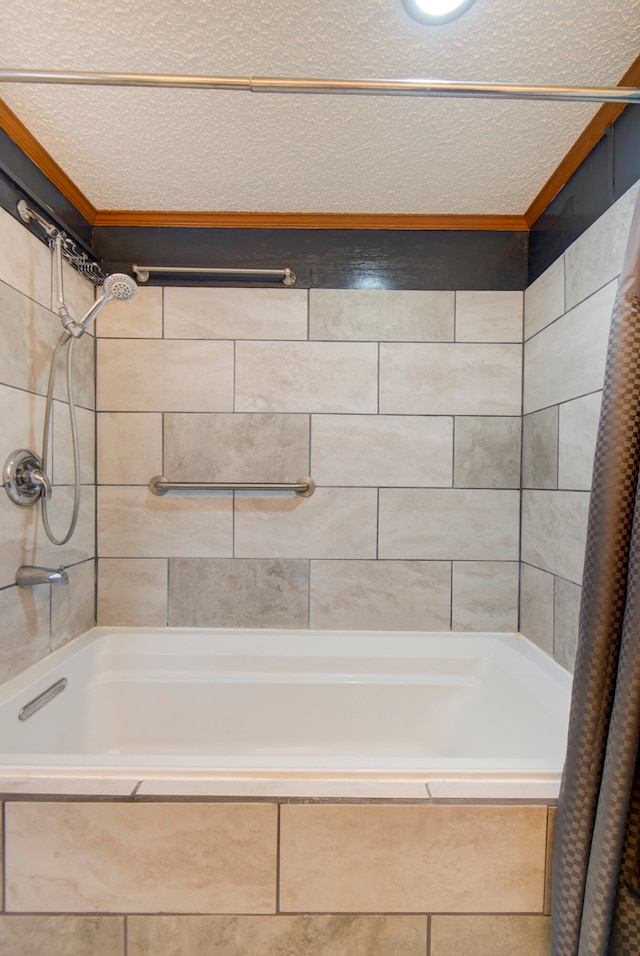 bathroom featuring shower / bath combo with shower curtain and a textured ceiling