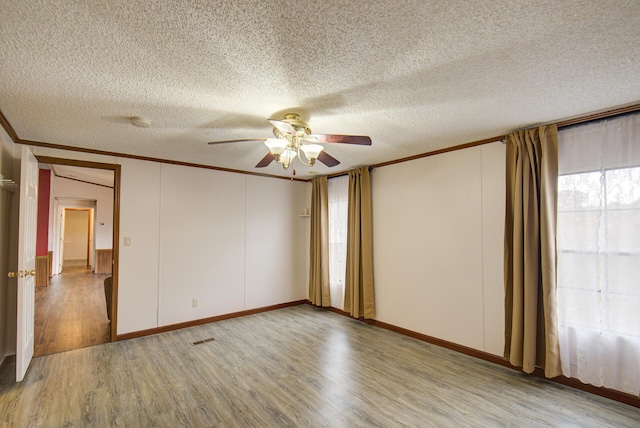134 Old Spring Rd, Rising Fawn, GA 30738 - unfurnished room featuring ornamental molding, a ceiling fan, light wood-style flooring, a textured ceiling, and a decorative wall