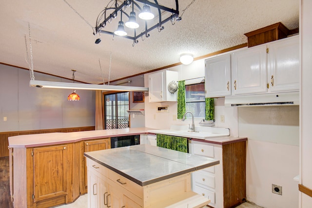 kitchen with decorative light fixtures, a textured ceiling, white cabinets, beverage cooler, and kitchen peninsula