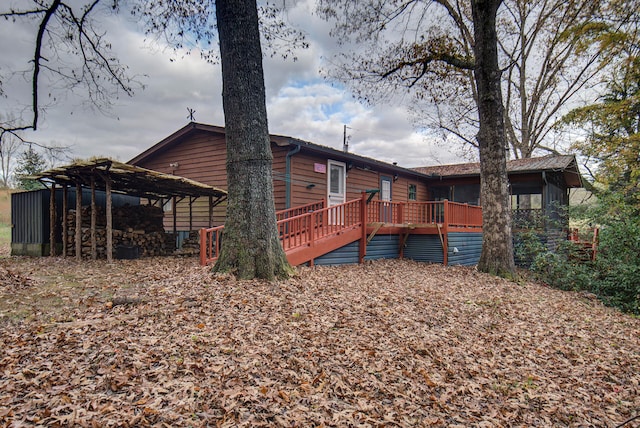 rear view of property with a wooden deck