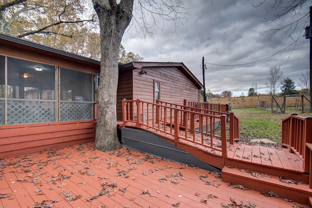 wooden deck with a sunroom