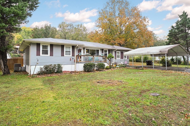 ranch-style house featuring a wooden deck, a carport, a front lawn, and central AC unit